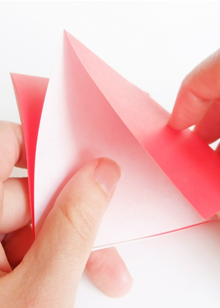 Hands folding paper into flexagon for CAGIS activity