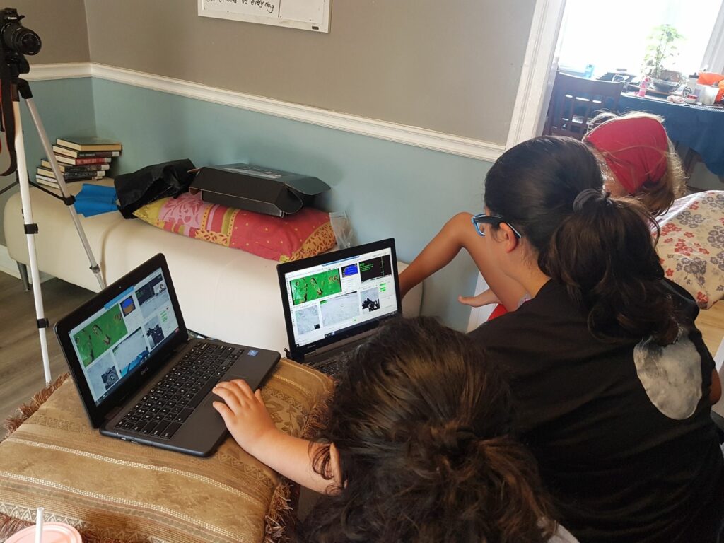 Young people on laptops attending virtual Junior Astronaut Camp