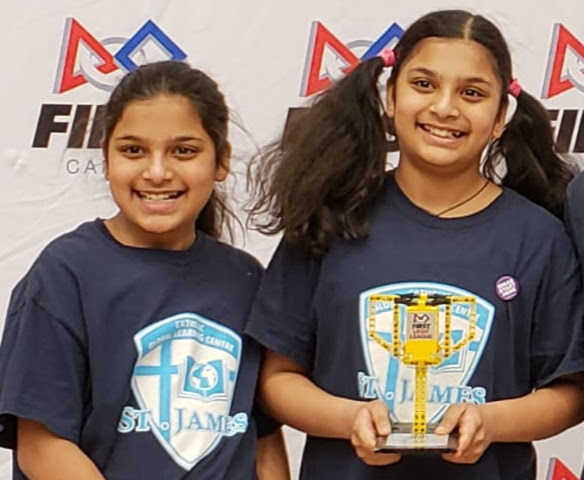 A young Bianca and Daniella holding one of their first robotics award