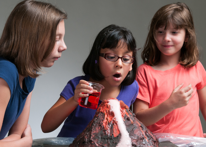 Girls making a volcano