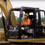 Construction worker driving an excavator